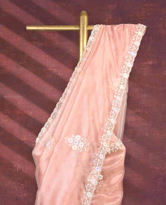 Peach colour pure organza saree featuring all over floral sequin work, adorned with a matching intricately worked floral border, complemented by a richly embellished pallu and paired with a heavily worked matching blouse.