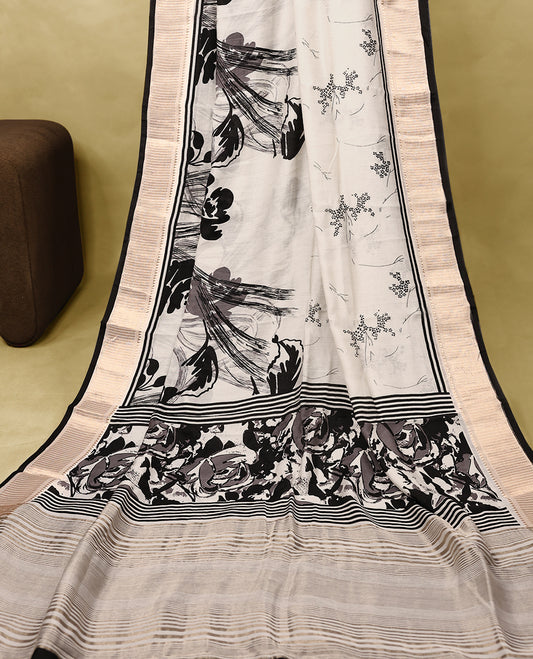 Off White colour Viscos semi printed saree featuring a golden zari border, Black printed motifs across the body, and comes with a matching blouse