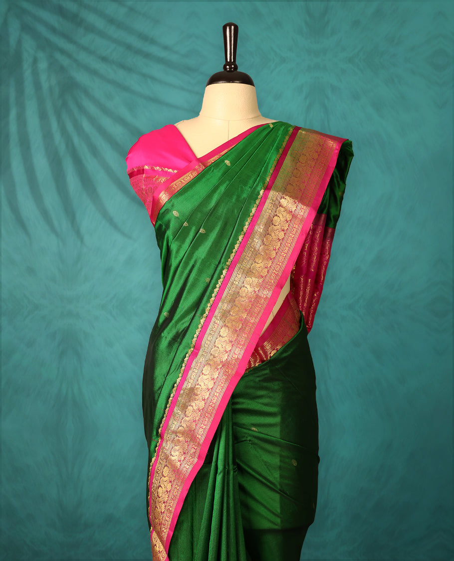 Deep Green colour Dharmavaram saree with small gold motifs on body, Magenta traditional border with intricate gold zari weaving, grand zari pallu, perfect for Bharatanatyam, with matching blouse.