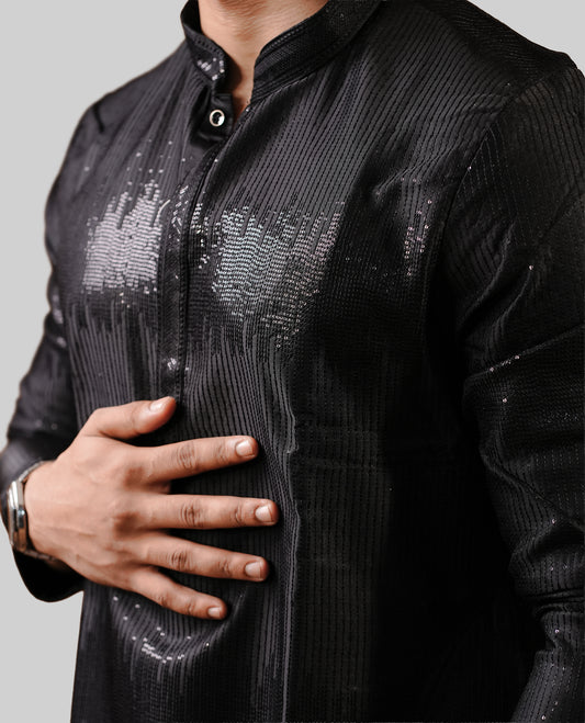 Black colour men's kurta featuring elegant thread and sequins work on the body, complemented by full sleeves for a refined and festive look.