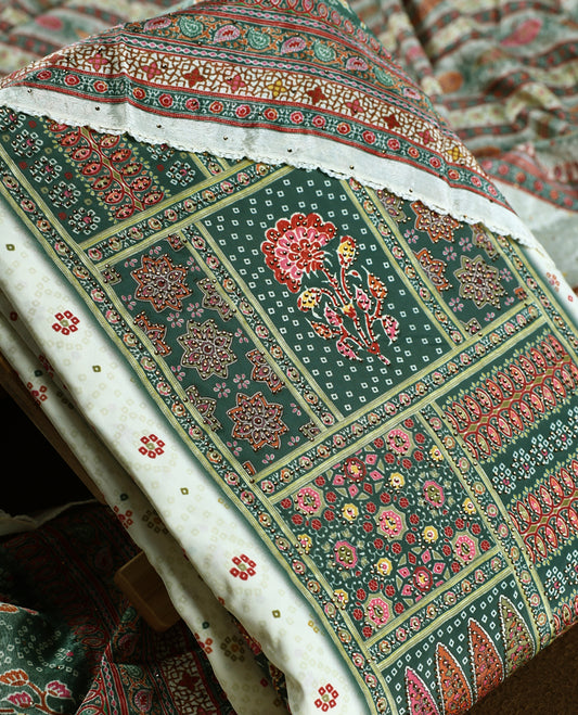 Cream colour churidhar material featuring intricate green colour traditional floral and block prints in red and gold, paired with a plain white bottom and a matching printed dupatta.
