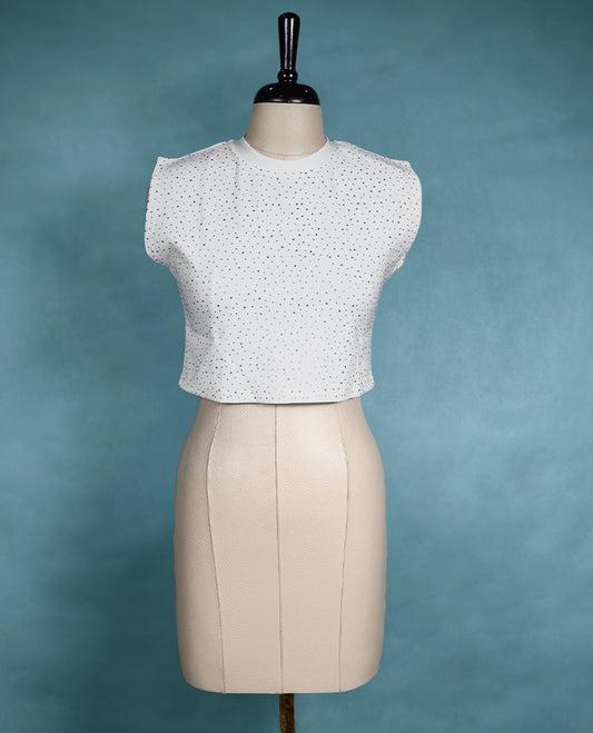 White sleeveless crop top featuring a round neck and all over small stone dot pattern for a chic, minimal look.
