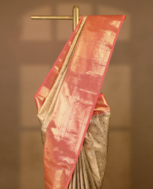 Gold colour tissue brocade saree with gold and silver zari floral & Geometric pattern on body, gold zari traditional floral and peacock work Peach border, rich matching pallu with Antique zari motifs, paired with matching blouse.