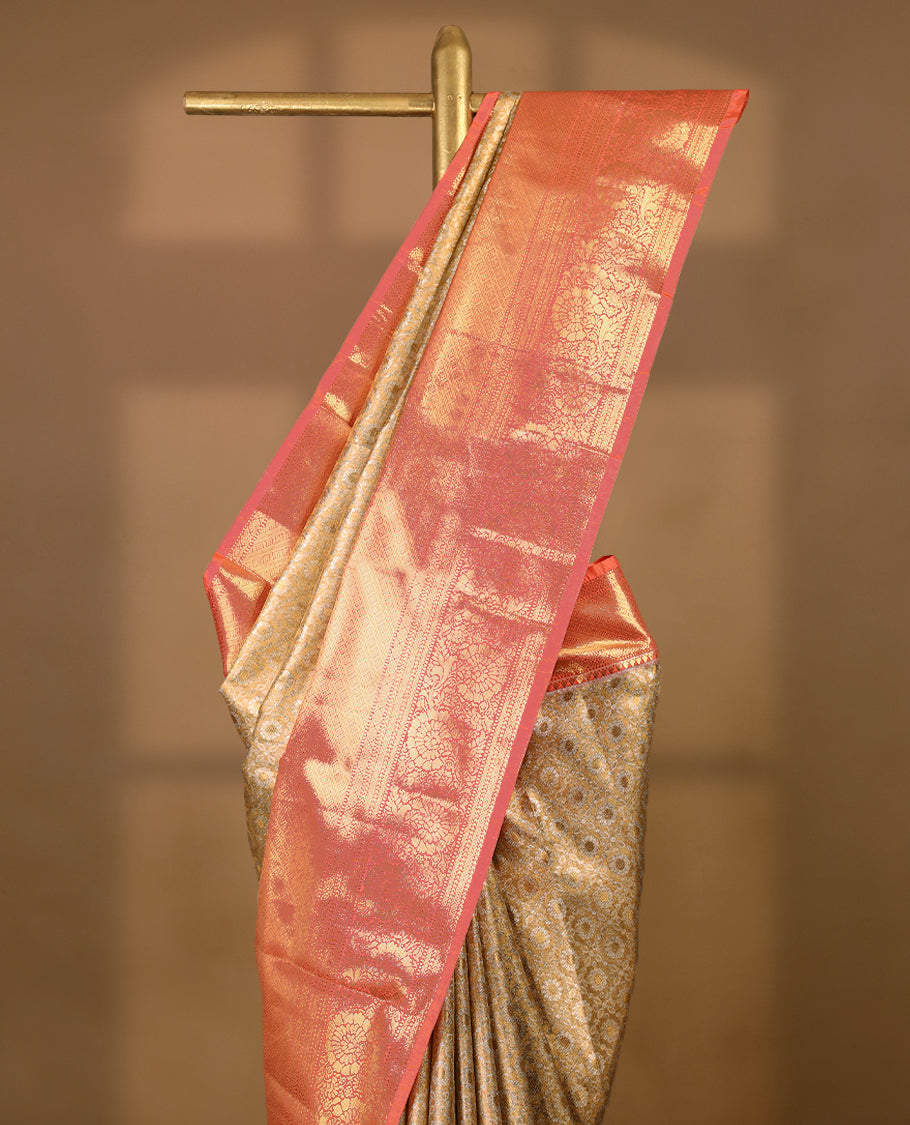 Gold colour tissue brocade saree with gold and silver zari floral & Geometric pattern on body, gold zari traditional floral and peacock work Peach border, rich matching pallu with Antique zari motifs, paired with matching blouse.