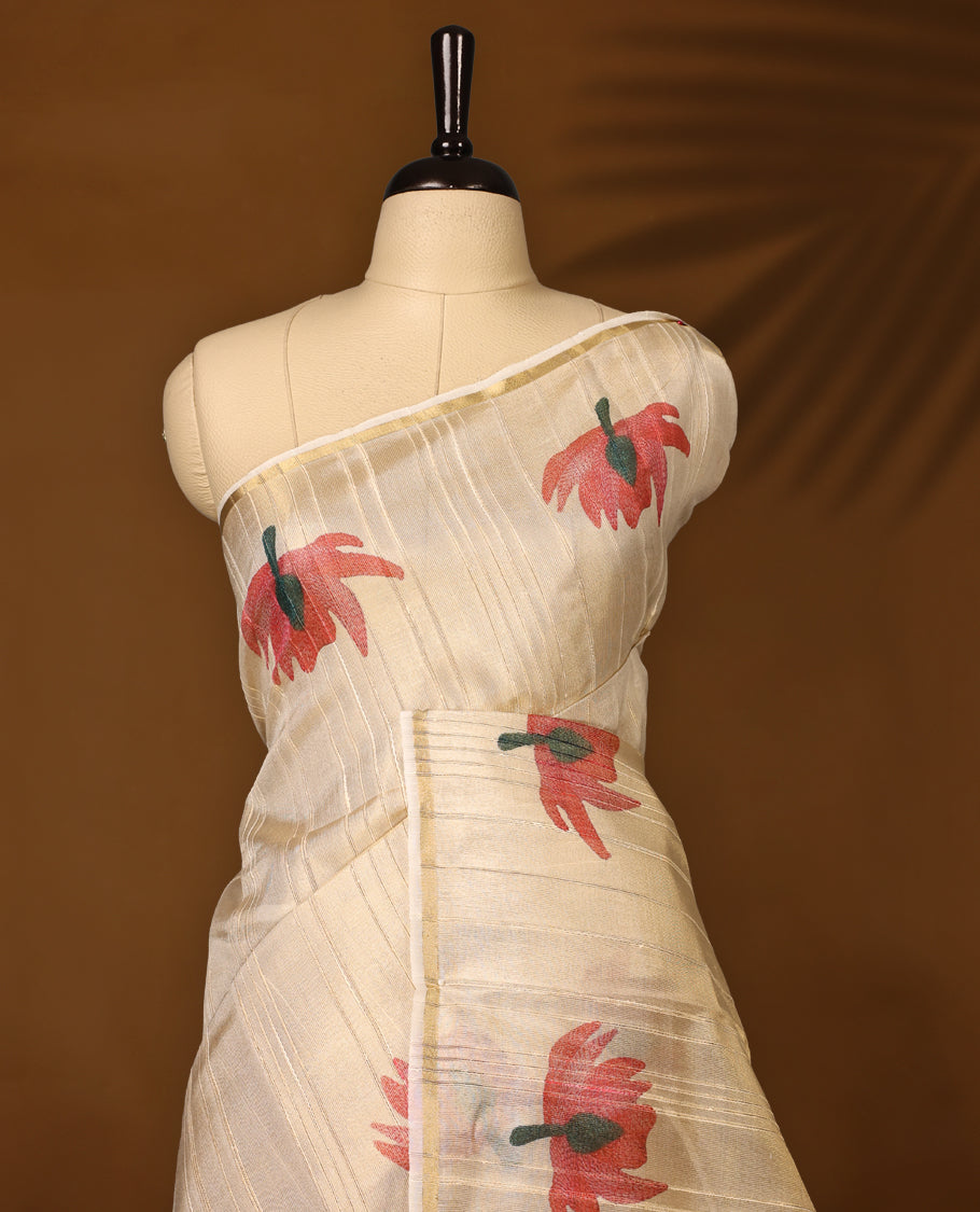 Elegant off white colour organza Kerala saree with golden sheen and floral prints, paired with a matching blouse, Features a flowy texture and tasselled pallu, Perfect for festive, casual, or semi-formal occasions.