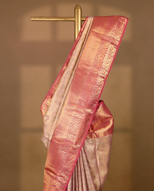 Golden Colour Kancheepuram tissue silk saree featuring intricate silver and pink Zari diamond motifs on the body, beautifully complemented by a contrasting traditional peacock and floral kodi design border, paired with a matching blouse.