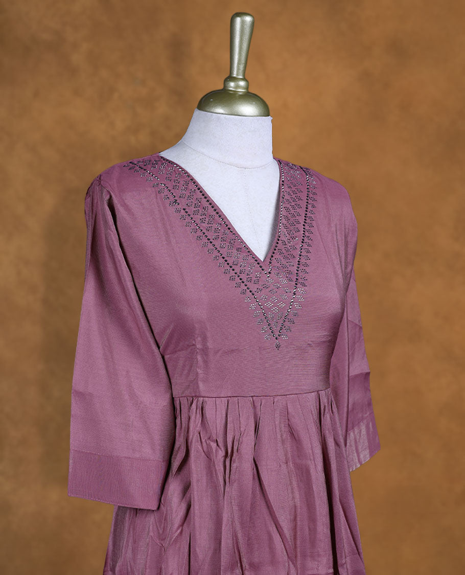 Dark mauve colour kurti highlighted with dainty cutwork along the V-neck yoke, styled with gentle gathers at the waist and comfy 3/4th sleeves.