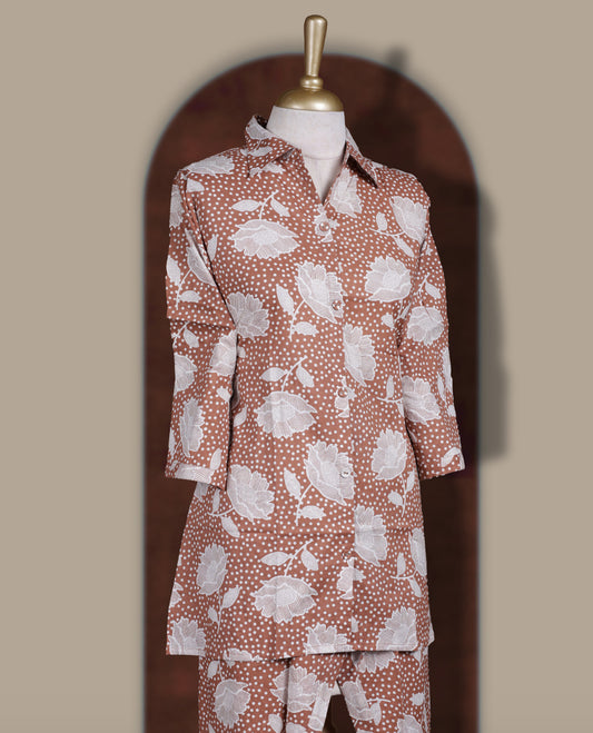 Soft brown colour cord set with bold white floral prints, Features a collared kurta with front buttons and 3/4 sleeves, paired with asymmetrical hem pants for a trendy and contemporary ethnic look.