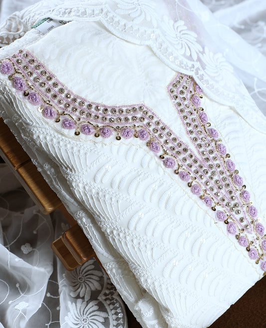 White colour churidhar material featuring delicate embroidery with violet colour sequins and bead highlights, paired with a plain white bottom & Comes with a matching embroidered net dupatta.