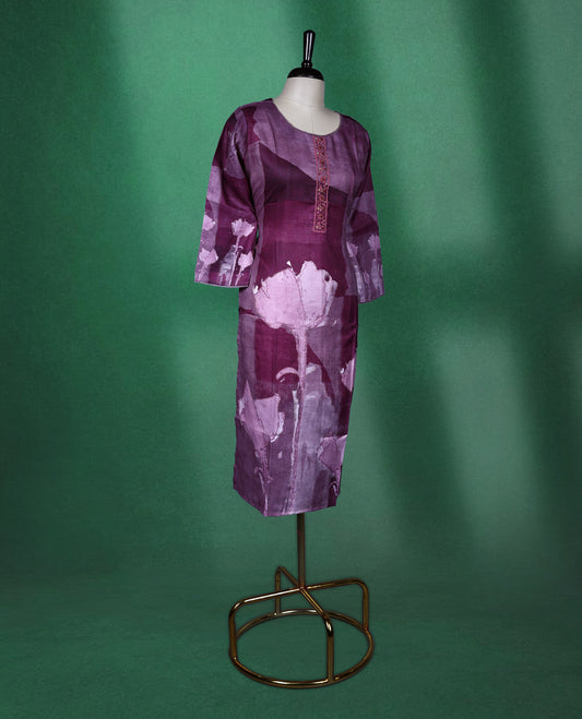 Plum purple colour kurti with a round neckline and three quarter sleeves, featuring abstract floral prints in soft lilac tones and a delicately Printed front placket for a graceful contemporary style.