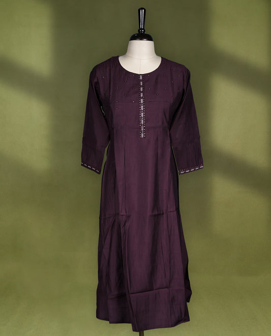 Rich Brown coloured kurti crafted in silk blend fabric, adorned with subtle beadwork on the yoke and embroidered placket, featuring a round neckline and 3/4th sleeves with embroidered cuffs.