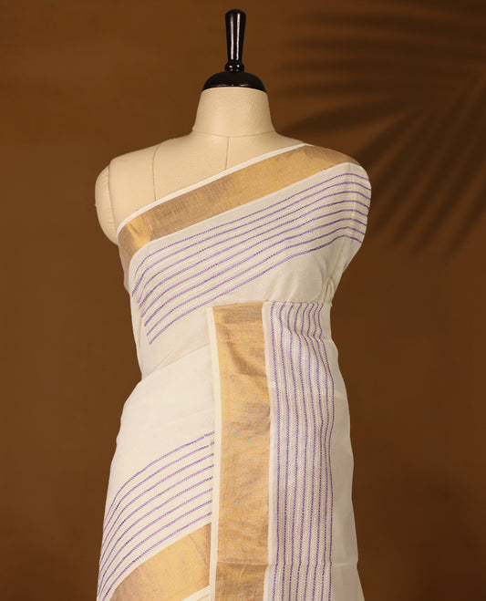 Elegant off white colour cotton Kerala saree featuring lavender colour Thread detailing on body, gold zari traditional kasavu border, Paired with matching blouse offering a classic and graceful look