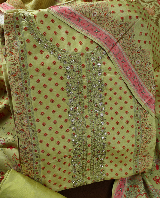 Olive green colour churidhar material adorned with subtle red prints and intricate embroidery on the neckline, paired with a beautifully printed dupatta and plain matching bottom.