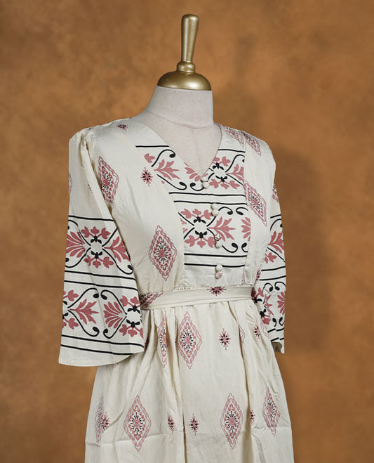 Ivory printed knee-length A-line dress with V-neckline, rose and black ethnic motifs, three-quarter sleeves, and a detachable waist belt for a cinched silhouette.