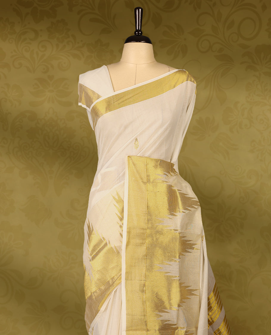 Off white colour pure narial handloom cotton saree with small gold zari motifs on  body, golden zari border, pallu highlighted with bold golden zari stripes and abstract temple design, with matching blouse