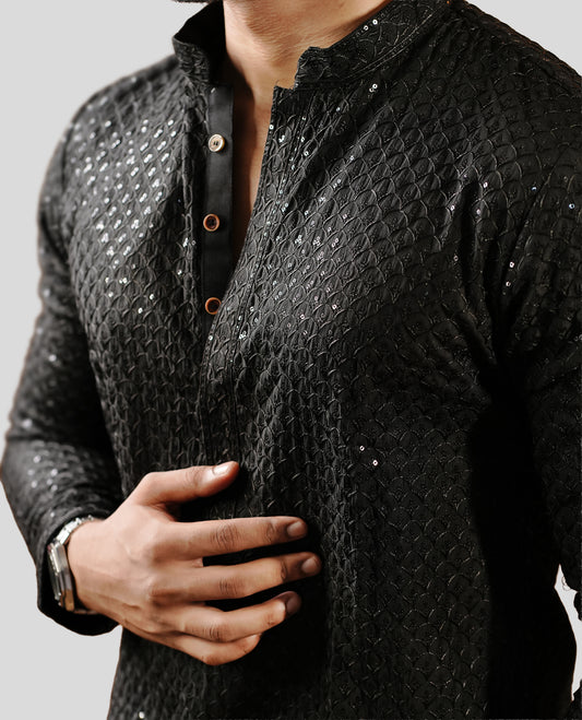 Black colour men's kurta featuring elegant thread and sequins work on the body, complemented by full sleeves for a refined and festive look.
