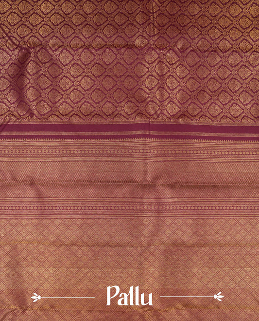 Dark burgundy colour Kanchipuram pattern Manthrakodi saree featuring metallic golden floral and leaf motif zari jaquard with kanchipuram traditional bavanji border and plain blouse piece with zari border.