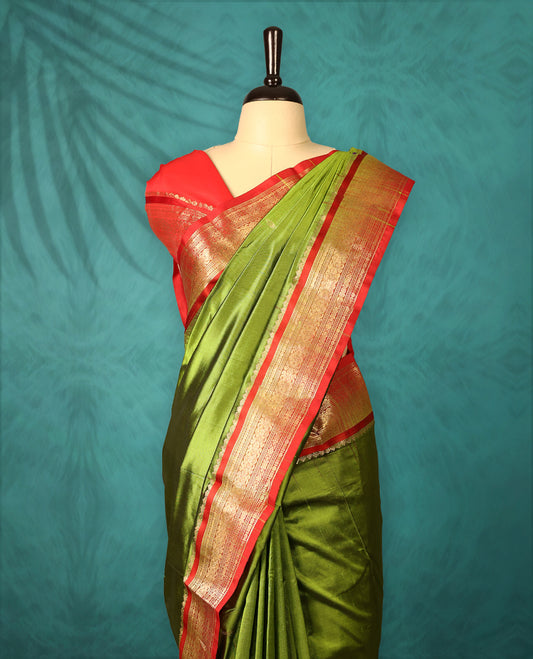 Olive Green colour Traditional Kancheepuram Silk saree with small gold motifs on body, Deep Red traditional border with intricate gold zari weaving, grand zari pallu, perfect for Bharatanatyam, with matching blouse.
