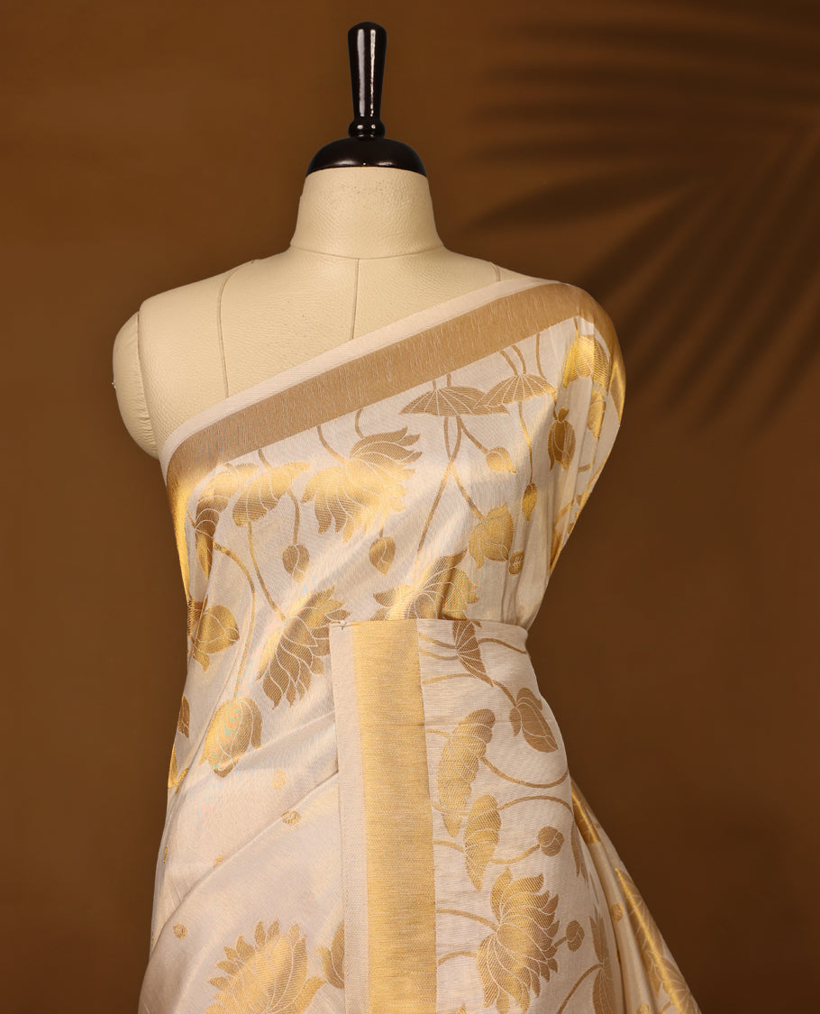Elegant off white colour soft tissue Kerala saree with golden floral weaving and zari border, Lightweight and sheer, paired with a matching blouse & ideal for festive and traditional occasions.