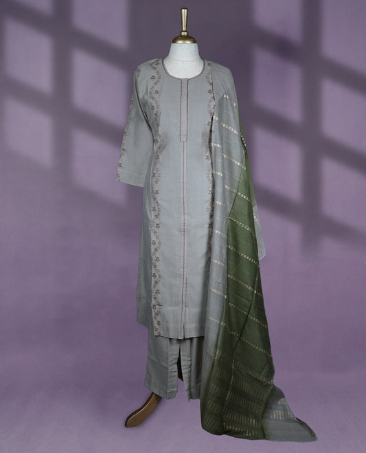 Sophisticated grey colour kurti set features a round neck with a keyhole slit, three-quarter sleeves with subtle embroidery, and is complemented by straight pants and a contrasting green dupatta with delicate golden patterns.