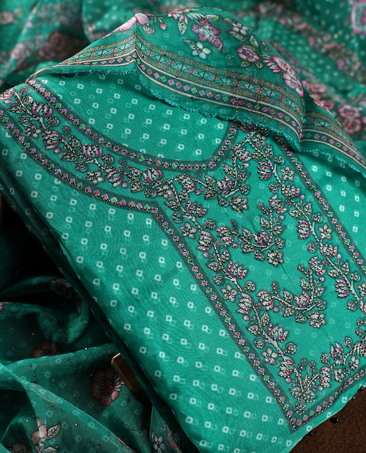 Teal green churidhar material featuring a printed top with delicate floral vine motifs, paired with a floral bordered dupatta and plain bottom & A perfect blend of elegance and comfort for festive and casual wear.