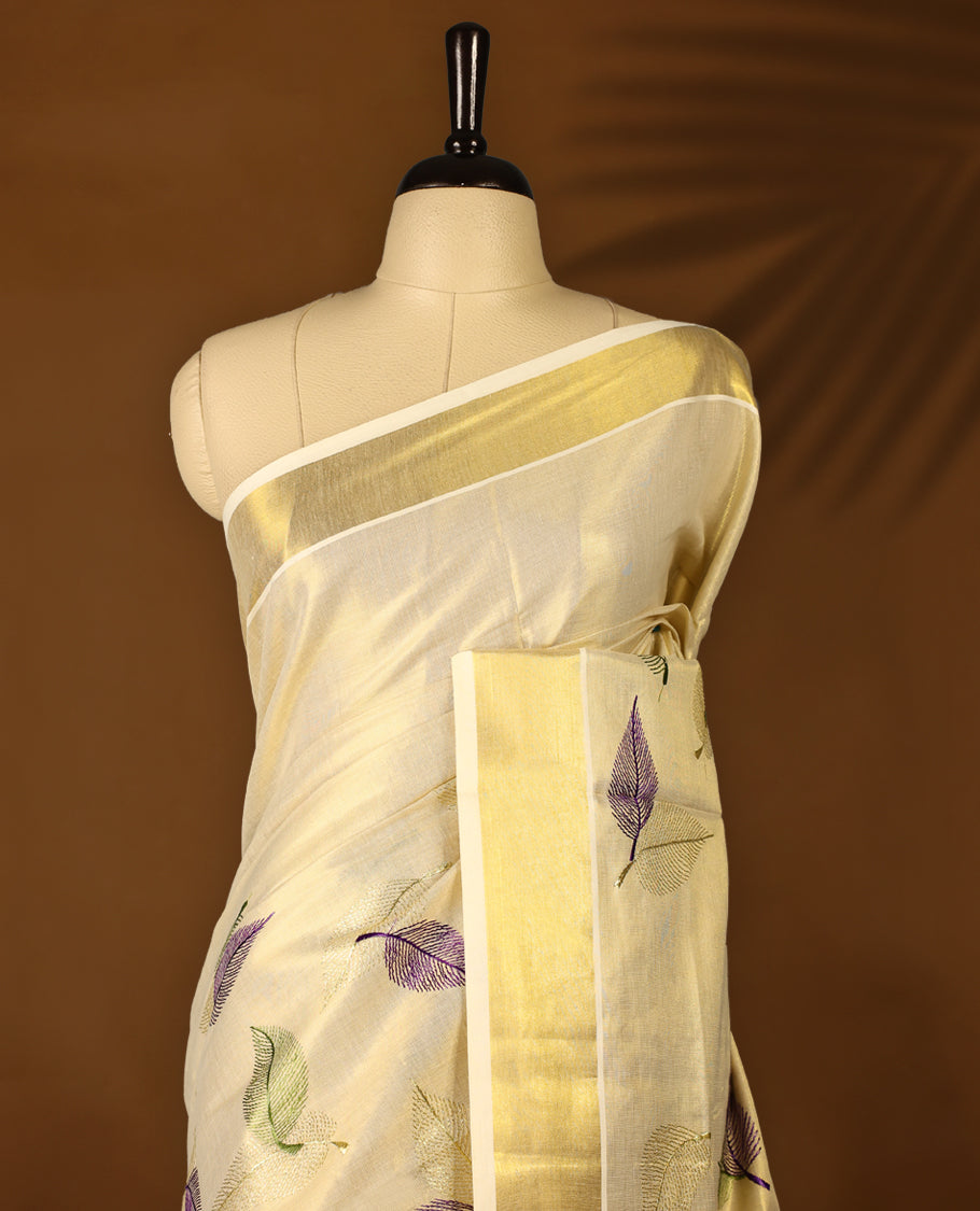 Light Gold colour Tissue Kerala saree featuring Leaves thread work on body and a beautifully woven Gold Kasavu border, paired with a matching blouse perfect for festive occasions.