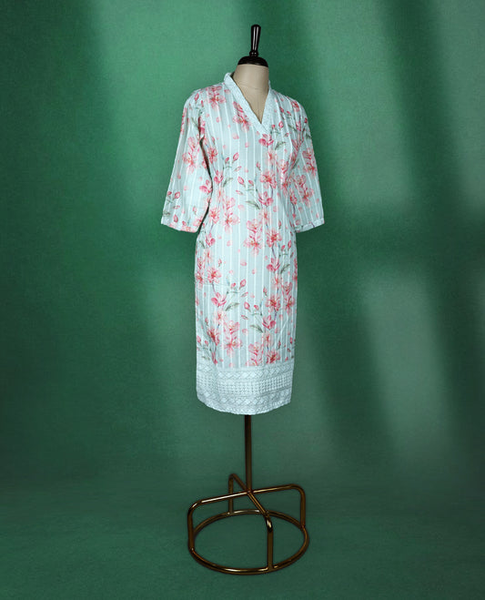 Mint green cotton kurti adorned with pink floral prints and white vertical stripes, featuring a V slit collared neckline, three quarter sleeves, and a white lace trimmed hem, fresh and feminine pick for everyday comfort.
