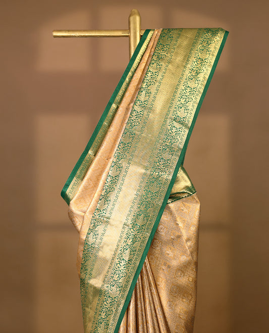 Gold colour tissue brocade saree with gold and silver zari flower and Diamond pattern on body, gold zari floral kodi work Green border, rich matching pallu with Antique zari motifs, paired with matching blouse.