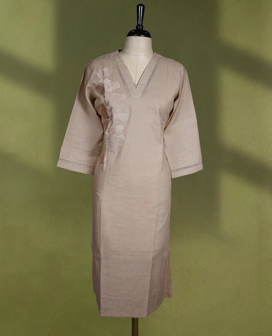 Beige colour kurti with a V neckline and three-quarter sleeves, adorned with subtle floral embroidery and minimal stitch detailing