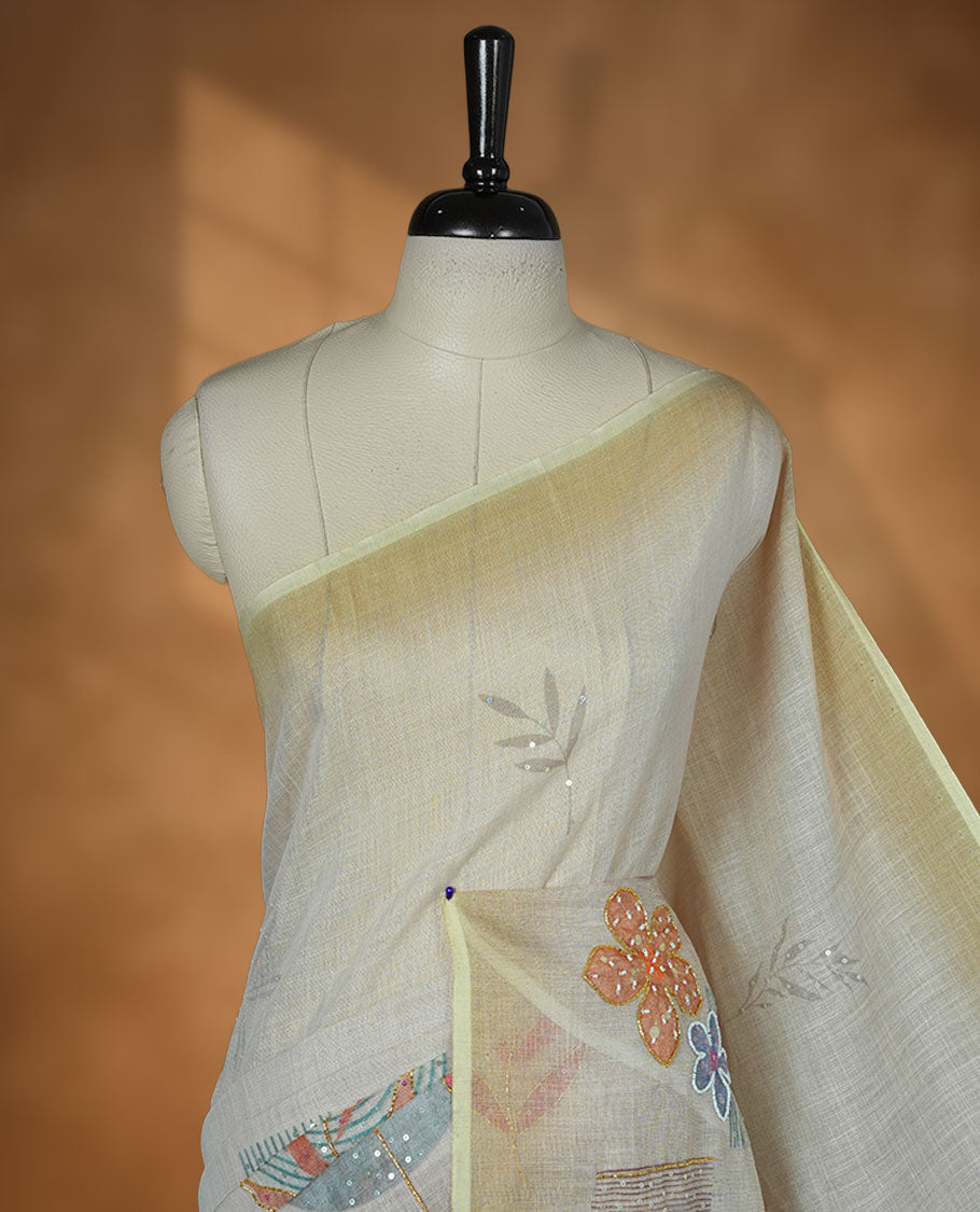 Cream colour linen silk saree featuring Light green colour fade border with floral beats pattern around floral print across body without border, pallu and matching blouse piece.