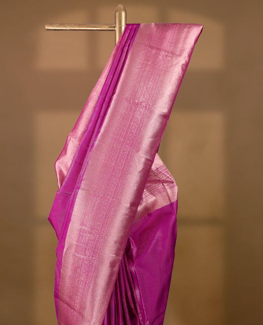 Pink Colour Manthrakodi saree featuring tissue weaving with a plain body, complemented by a self coloured traditional border and a matching self coloured blouse.
