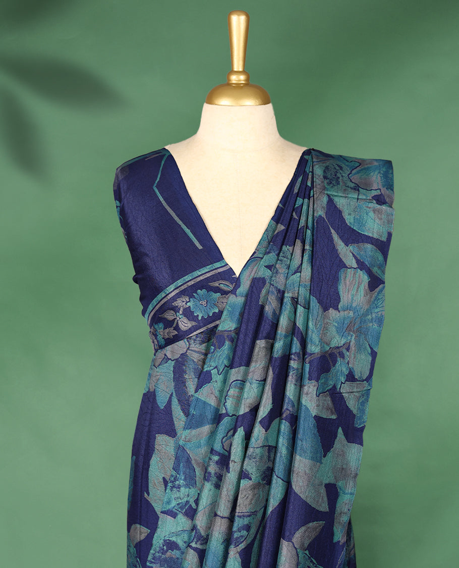 Navy blue colour Manipuri saree adorned with oversized turquoise and teal floral prints, crafted in a smooth finish with a clean, borderless silhouette and a matching blouse.