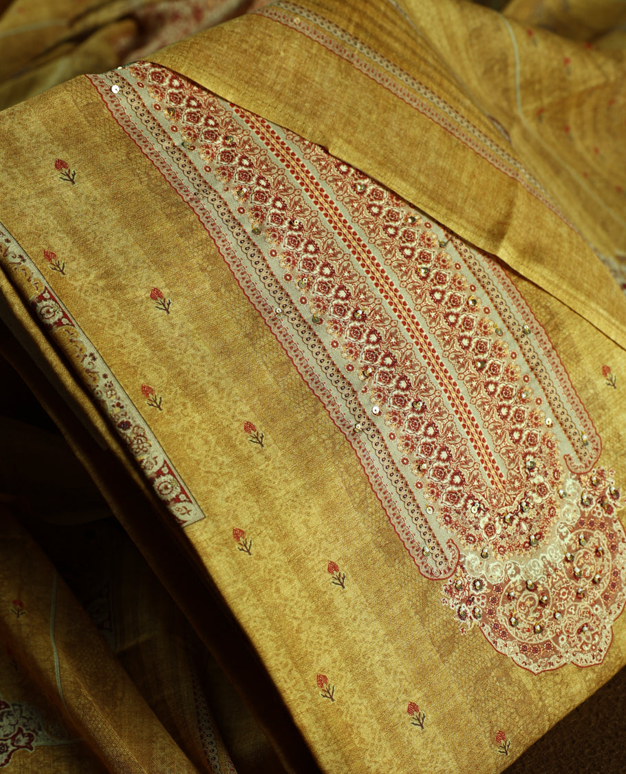 Mustard colour churidhar material with elegant maroon embroidery and delicate motifs, complemented by a plain matching bottom and dupatta.