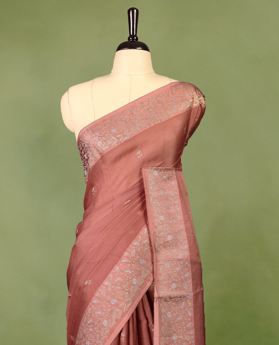 Pastel brown colour pure Banaras crepe saree showcases elegant Gold zari Flower Motifs all over the body, a traditional gold & Silver zari border, a rich intricately woven pallu, and comes with a matching blouse.
