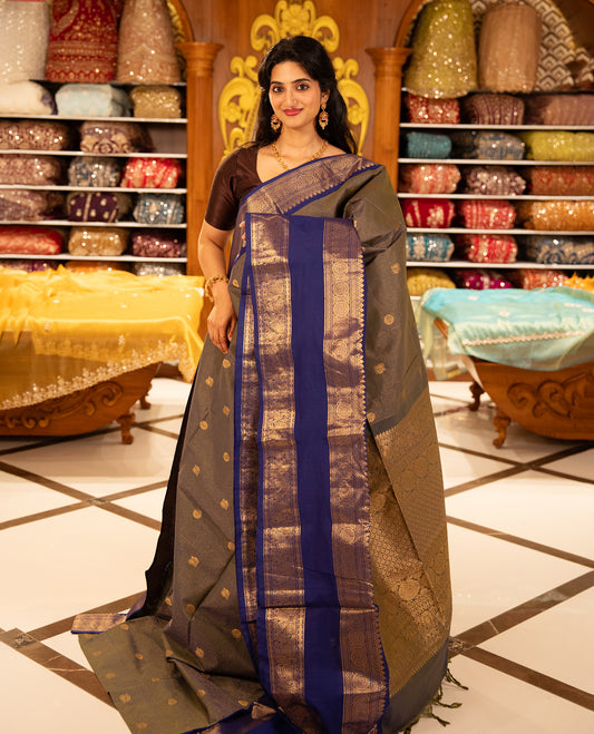 Green & Blue double shade Chettinad cotton saree featuring Gold zari strips with peacock motifs on body, complemented by contrast colour border with zari design & grand pallu, comes with matching blouse piece.