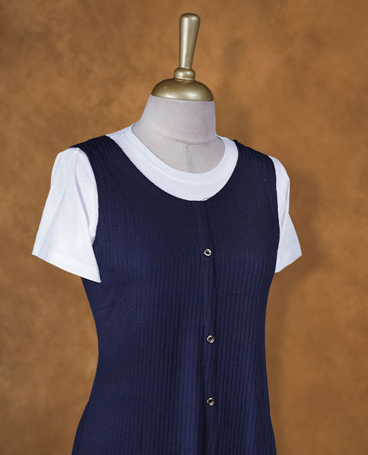 Navy blue sleeveless A-line midi dress with front button detailing, layered over a white crew-neck short-sleeve inner tee.