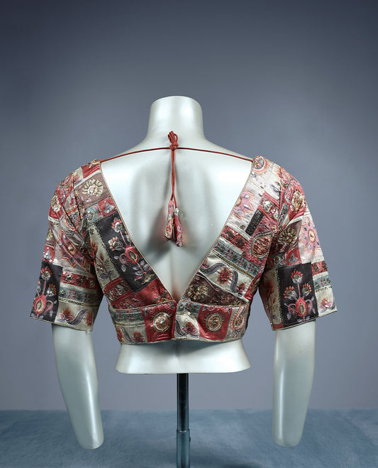 Multicolour patchwork designer padded readymad blouse featuring deep maroon, beige, and copper tones with paisley and floral motifs, crafted with elbow length sleeves and a deep V neckline.