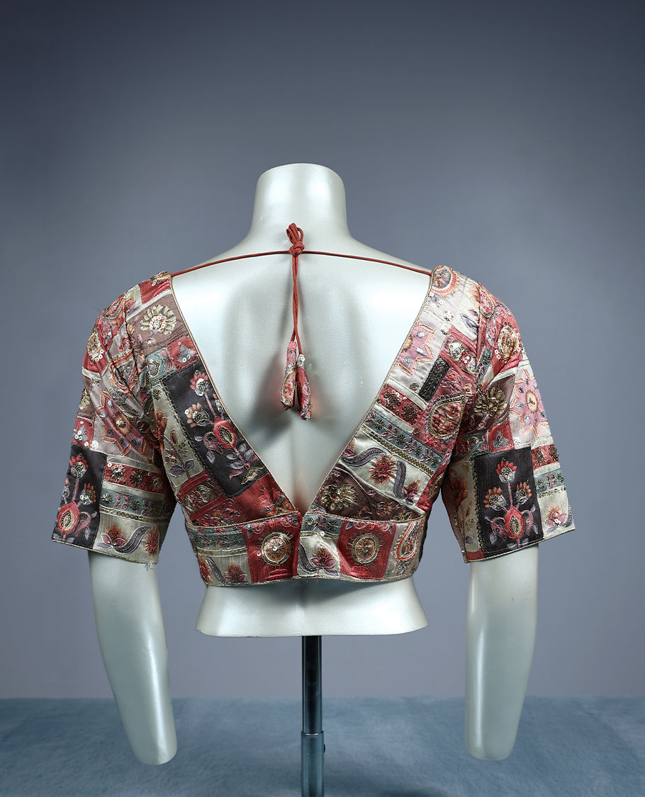 Multicolour patchwork designer padded readymad blouse featuring deep maroon, beige, and copper tones with paisley and floral motifs, crafted with elbow length sleeves and a deep V neckline.