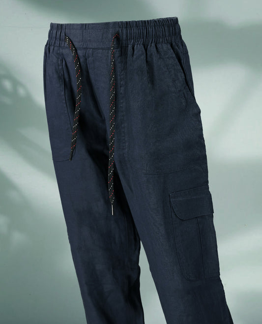 Navy blue colour cargo style pants featuring a relaxed fit, multicolored drawstring closure, and spacious utility pockets