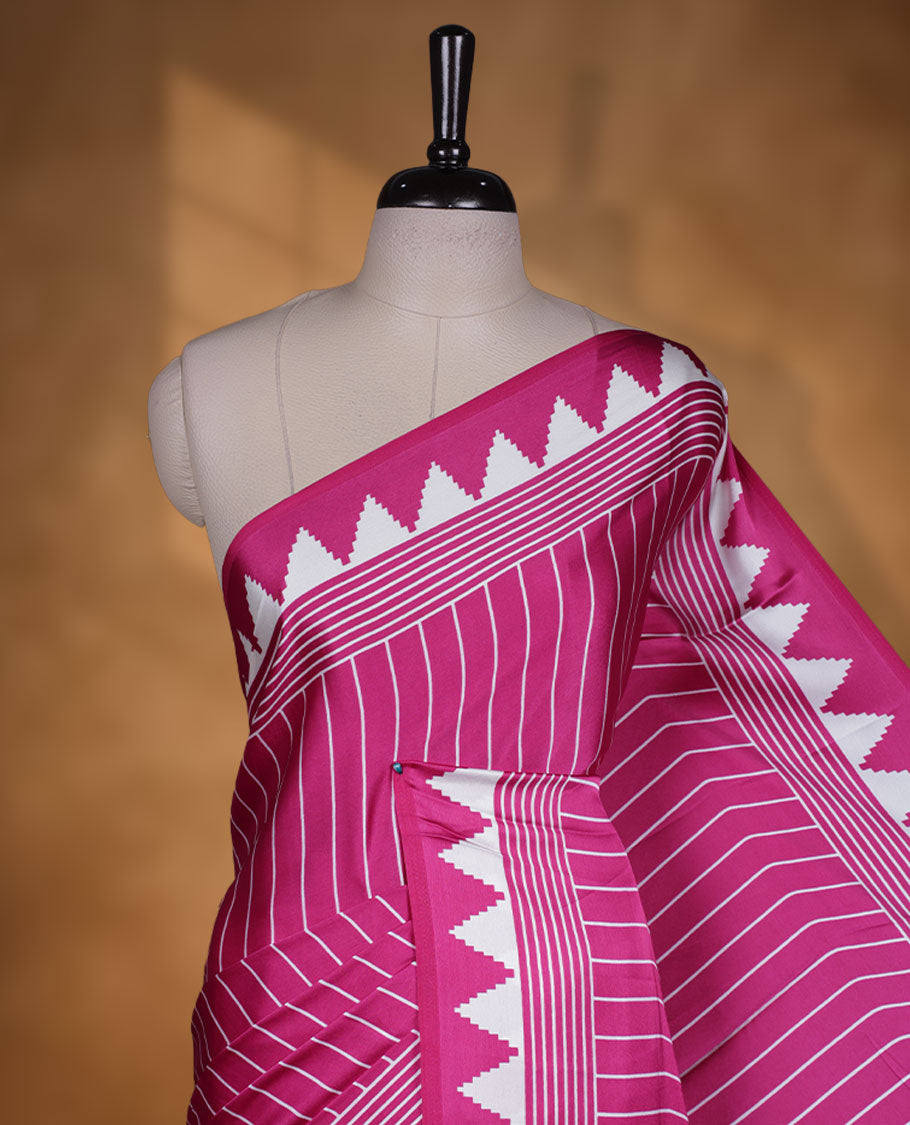 Dark Pink colour semi modal saree featuring bold white geometric borders and fine stripe detailing, finished with an oversized white circular motif on the pallu, paired with a matching printed blouse.