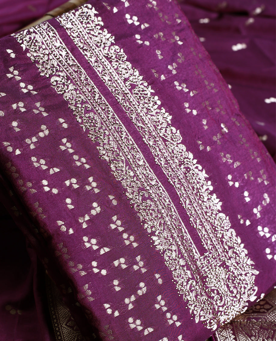 Grape colour churidhar material featuring golden zari woven motifs with an ornate traditional border, paired with a plain matching bottom and rich dupatta, perfect for weddings, festive occasions, and grand celebrations.