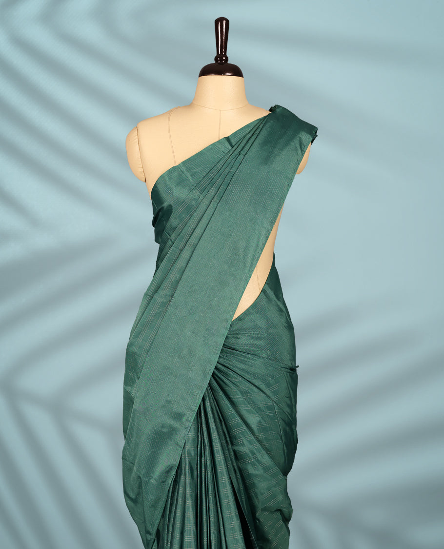 Pastel teal green Colour semi silk saree features subtle Silver zari check patterns throughout and Self Colour border, comes with a matching blouse