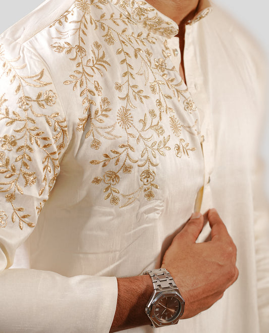 Cream colour men's kurta featuring elegant gold thread work on the body, complemented by full sleeves for a refined and festive look.