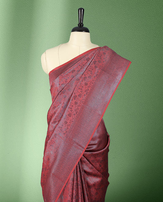 Brick Red colour semi silk saree featuring neem zari floral kodi motifs all over the body, complemented by a rich self colour woven border, with matching blouse.