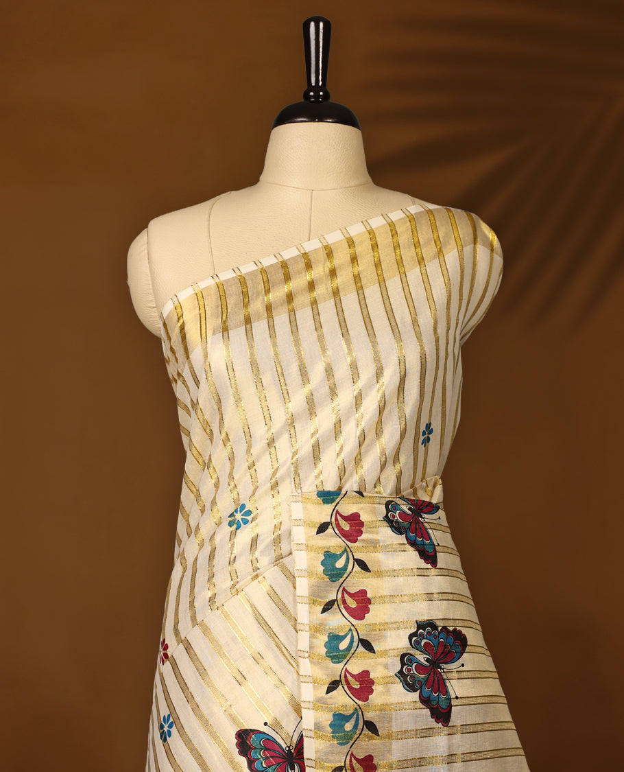 Elegant off white Kerala tissue saree with golden stripes, adorned with multicolor butterfly and floral motifs, and finished with a rich golden zari border with kodi prints perfect for a festive, graceful look with matching blouse.