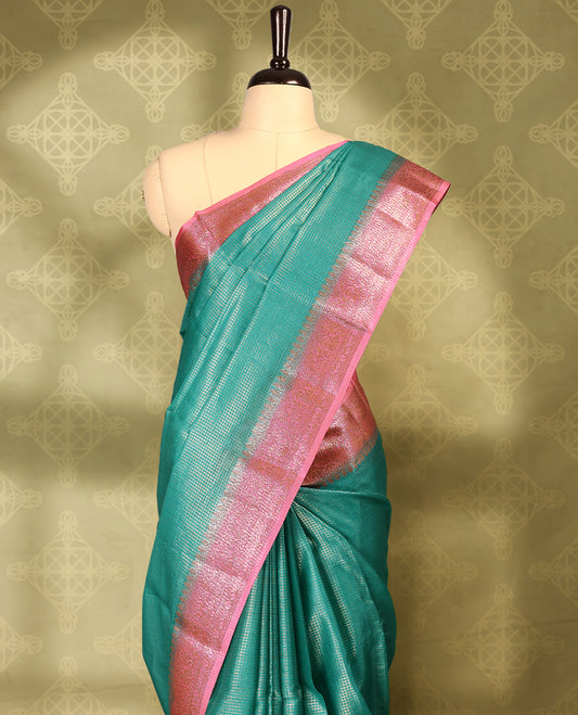 Peacock colour pure Banaras tussar silk saree with light gold zari small checked body, contrast pink border featuring copper and silver antique zari traditional work, antique zari brocade pallu, with matching blouse.