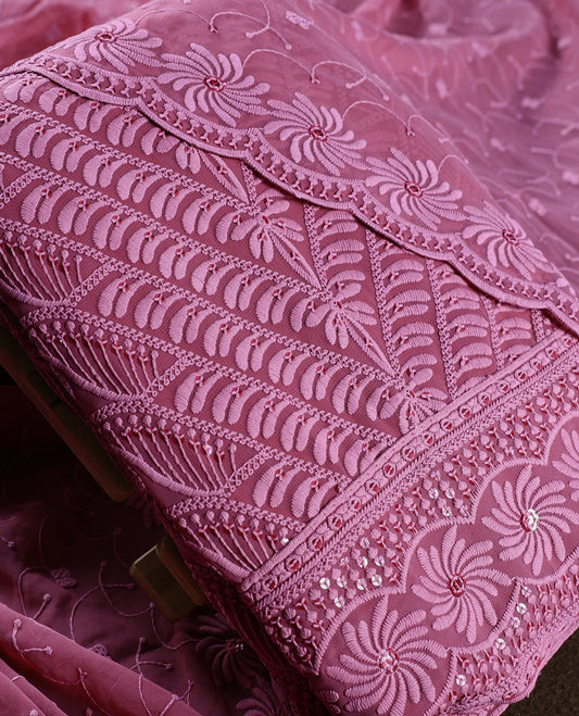 Graceful mauve pink churidhar material featuring rich floral embroidery with sequin accents, paired with a plain matching bottom and intricately embroidered dupatta, making it perfect for festive and elegant occasions.