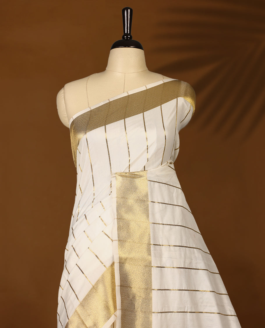 Elegant white colour sotf  Tussar Kerala saree featuring thin stripes on body, Gold kasavu border, Rich Pallu, Paired with matching blouse offering a classic and graceful look