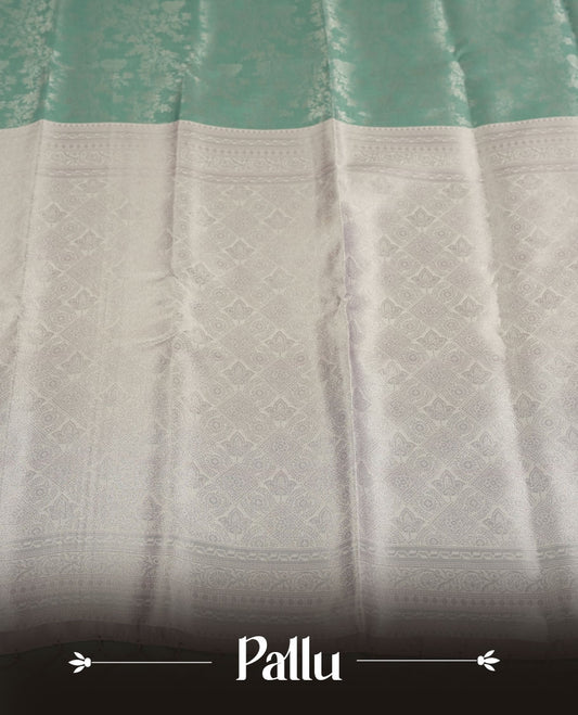 Seafoam Green colour Semi Silk Saree with Allover Subtle Floral Self-Weave on the Body, Contrasting Silver Zari Woven Pallu and Border Featuring Intricate Geometric Motifs and Tassels, Paired with Coordinated Blouse Piece