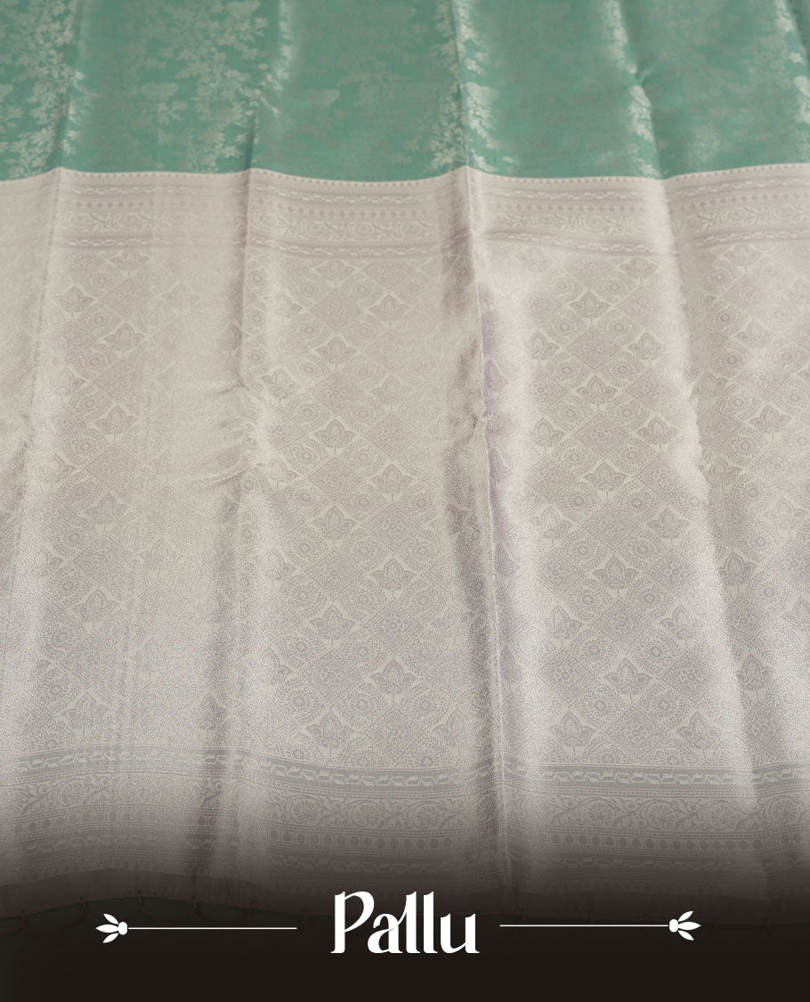 Seafoam Green colour Semi Silk Saree with Allover Subtle Floral Self-Weave on the Body, Contrasting Silver Zari Woven Pallu and Border Featuring Intricate Geometric Motifs and Tassels, Paired with Coordinated Blouse Piece